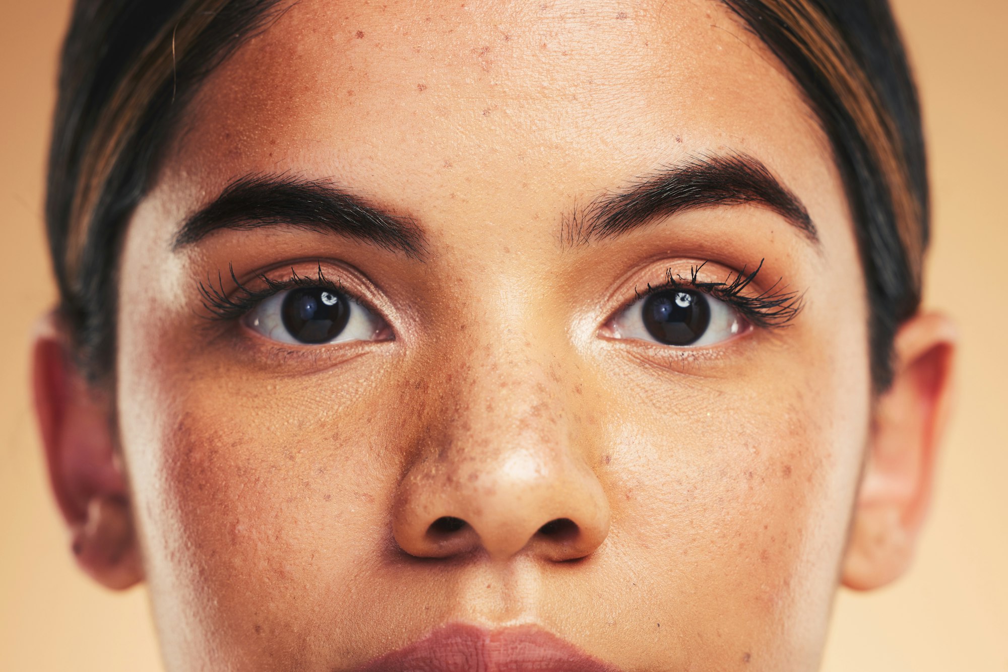 Woman, skin and closeup in studio portrait with beauty, cosmetics and natural glow on face by backg