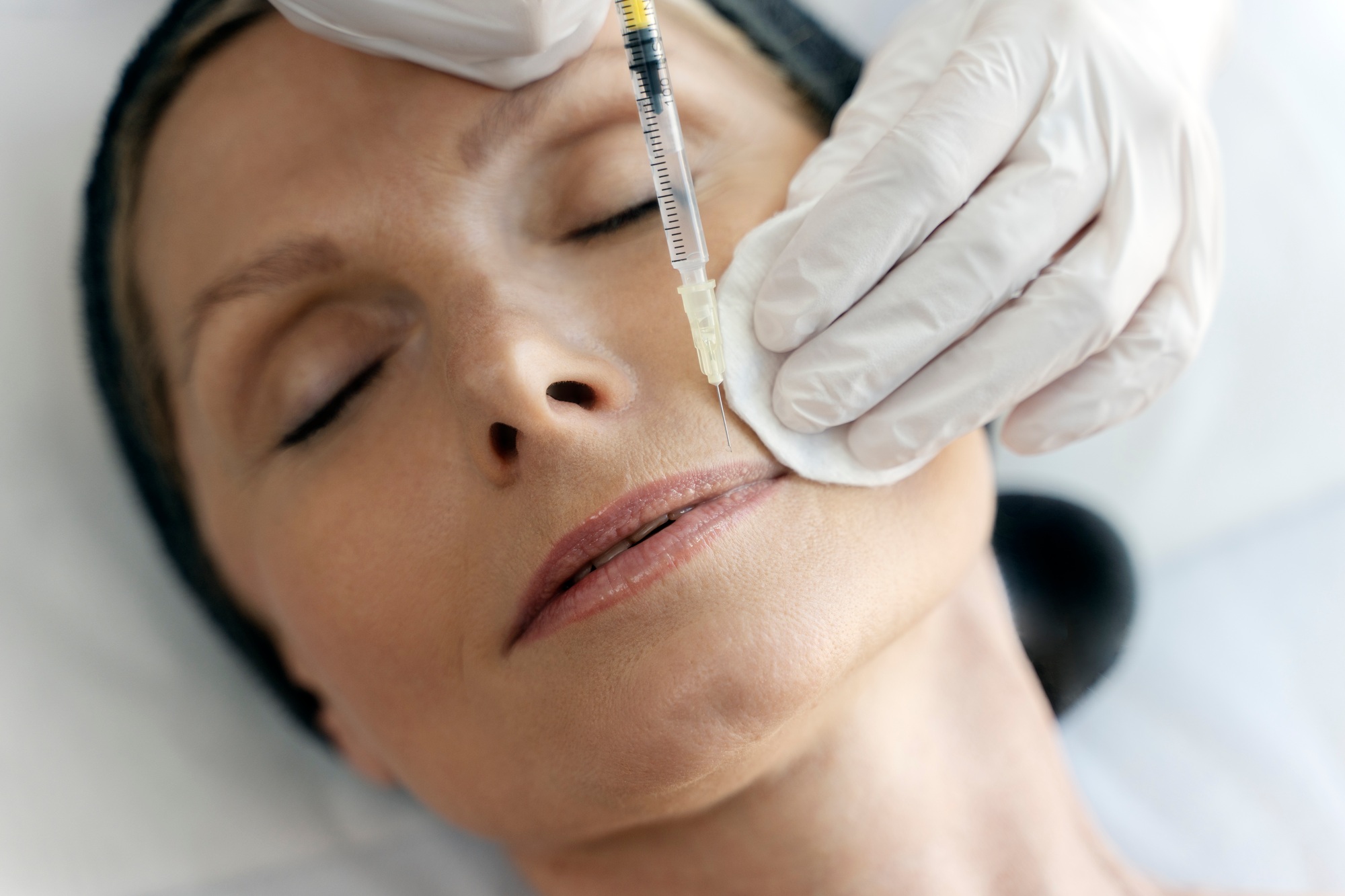 Close up view of the cosmetologist does prp therapy on the face of elderly woman