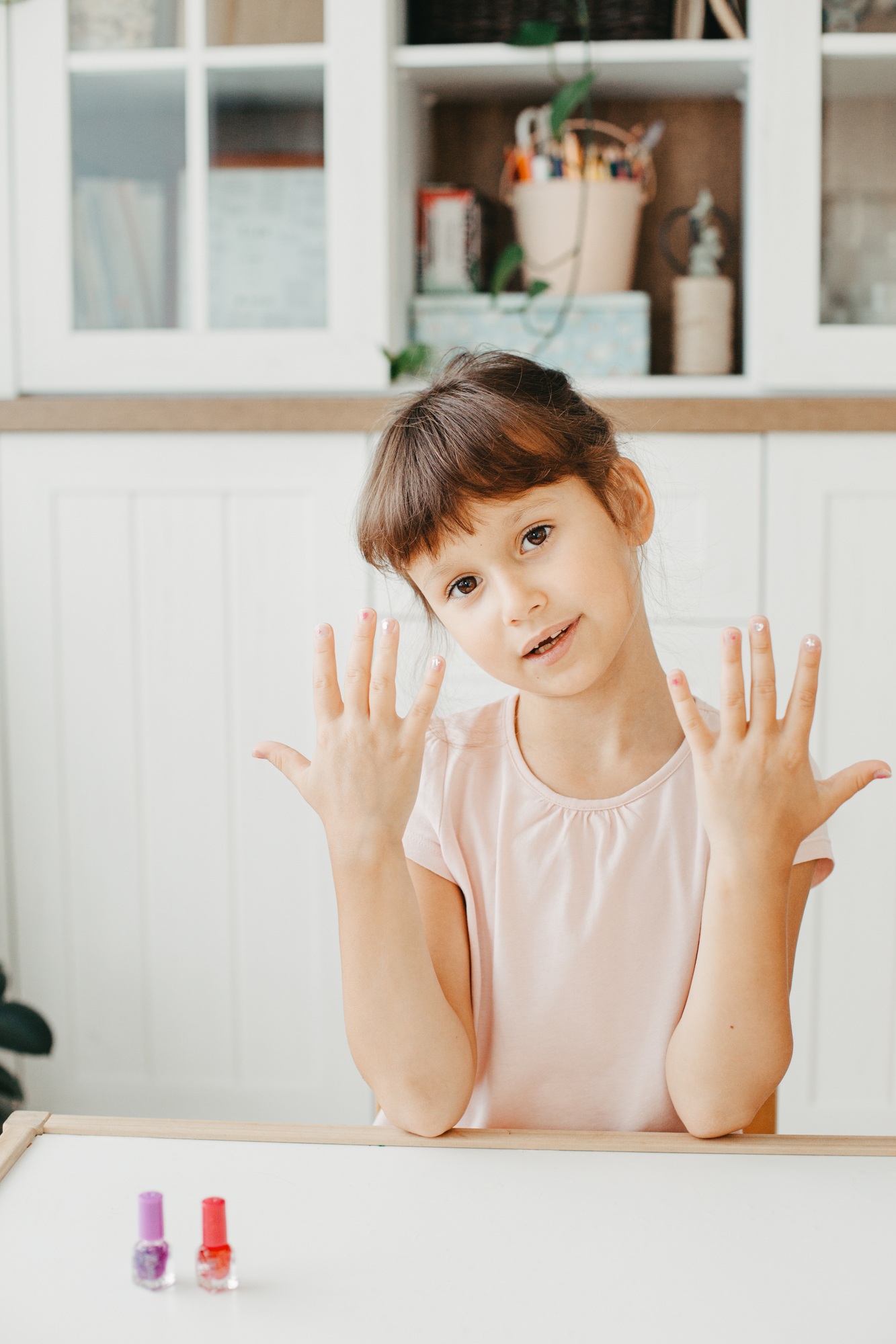 Six year preschooler girl show nails with nail polish