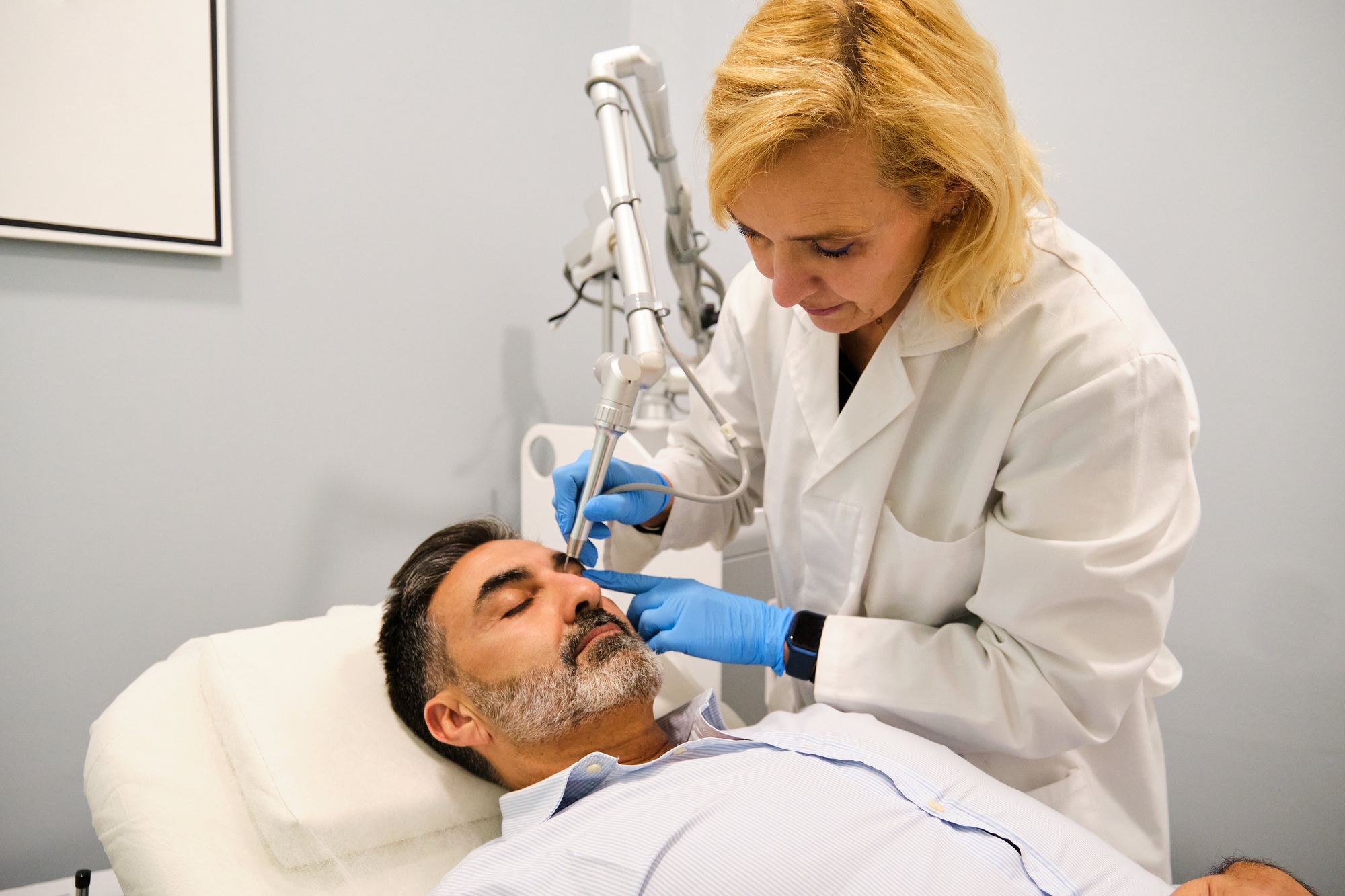 A man is getting a Non-Surgical Eyelid Lift or blepharoplasty.