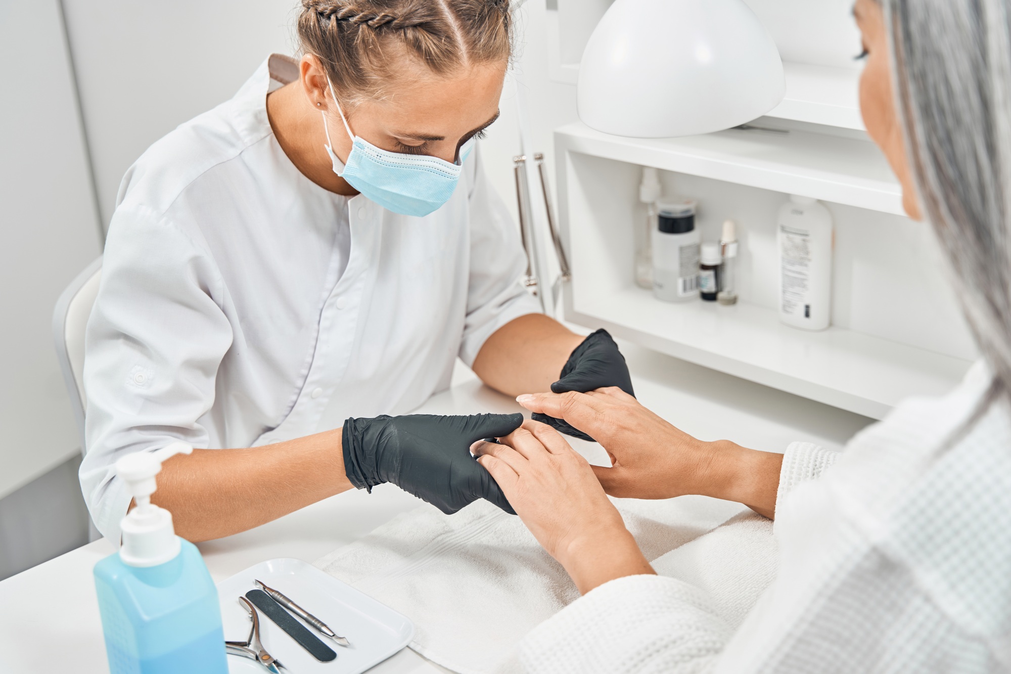 Close up of serious woman looking at nails