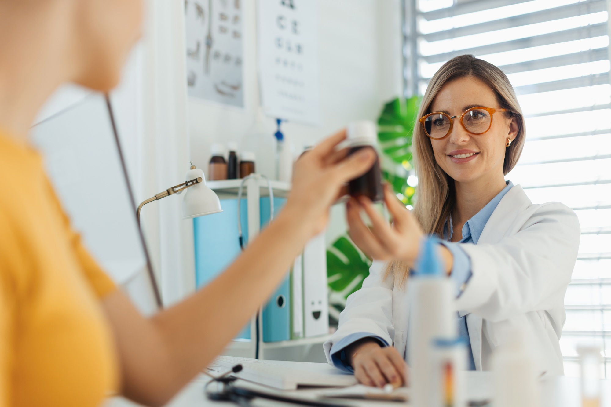 Teenage girl consulting on vitamins or supplements usage with paediatrician. Doctor prescribing