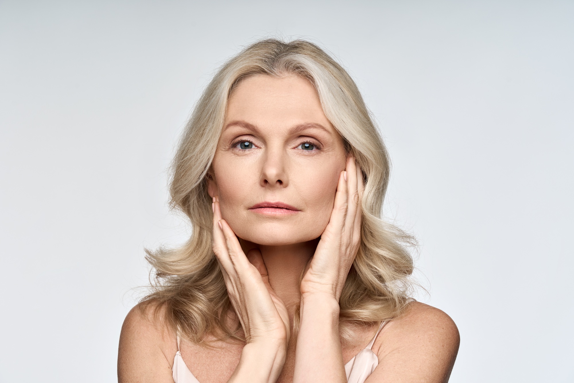 Portrait of beautiful 50 years old woman with perfect skin isolated on white.