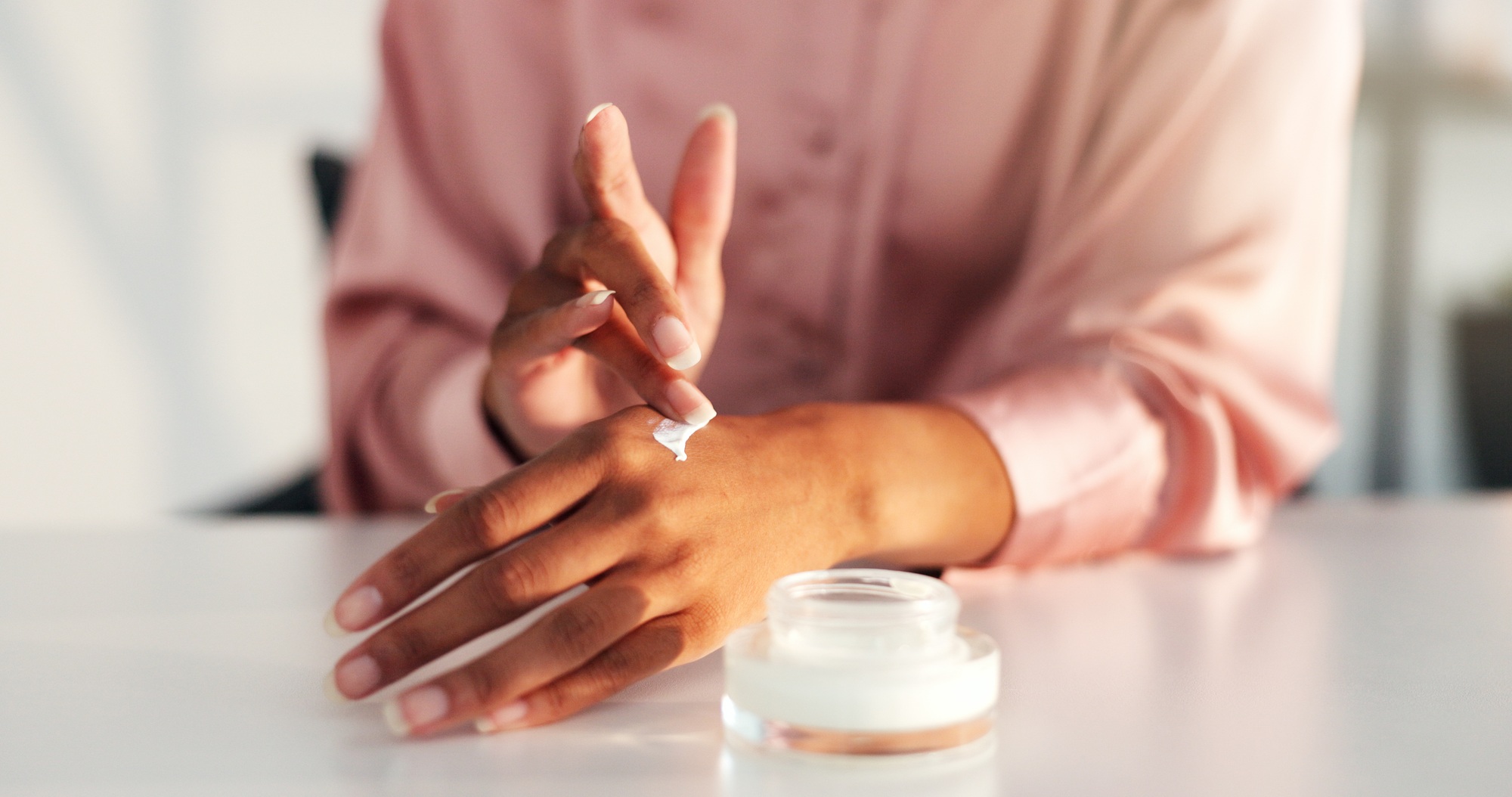 Woman, skincare and closeup of hands with cream for skin hydration, moisturizer and eczema treatmen