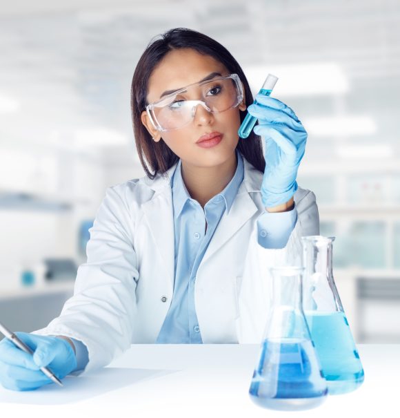 Female lab technician analyzing liquid sample